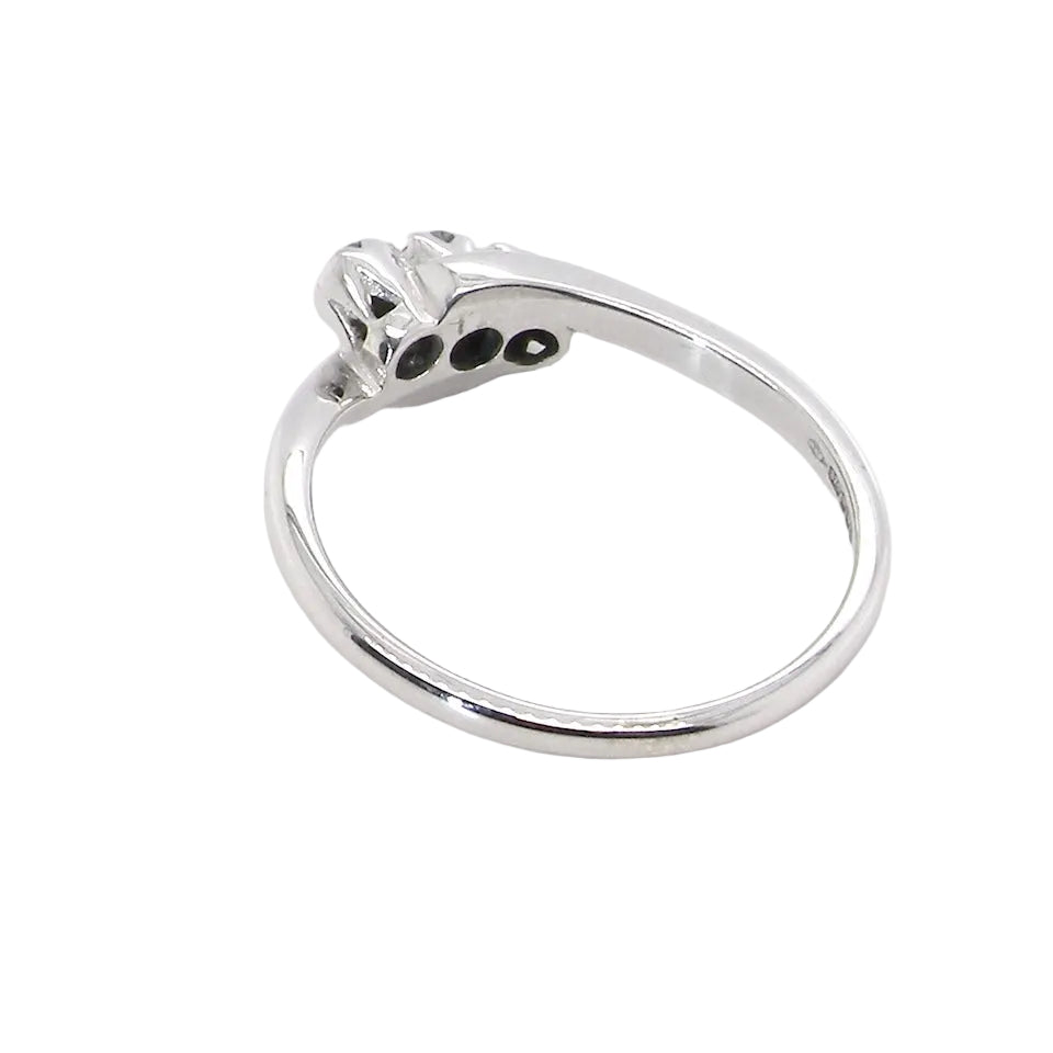 rear A 9 carat white gold cross over style trilogy ring. Three x 0.10mm diamonds, to an estimated at 0.30 carats.