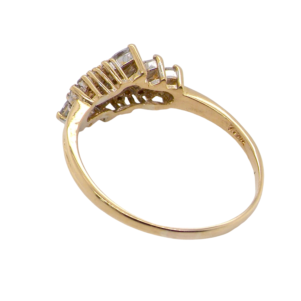 Gold ring with diamond accents on a white background