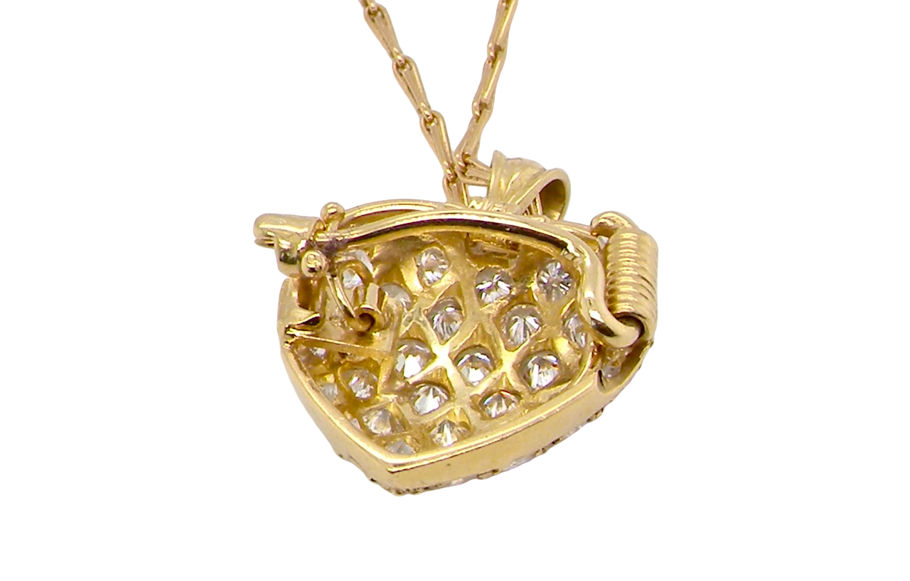 Gold necklace with a heart-shaped pendant on a white background