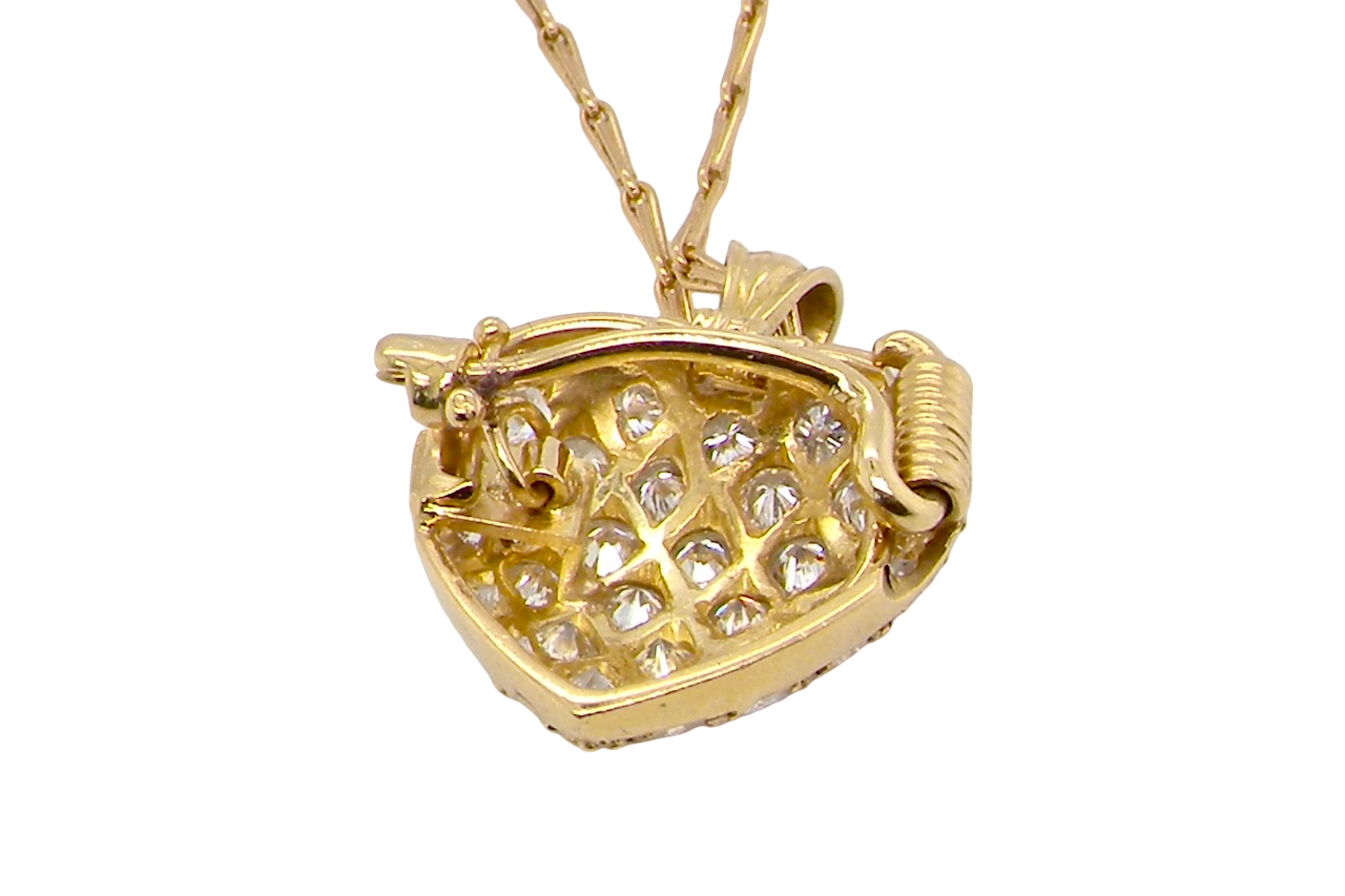 Gold necklace with a heart-shaped pendant on a white background