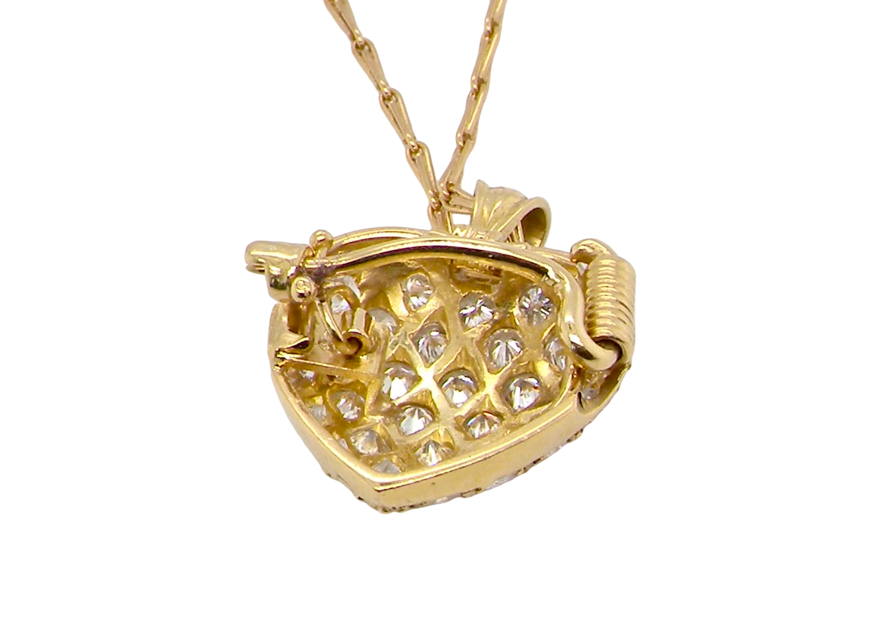 Gold necklace with a heart-shaped pendant on a white background