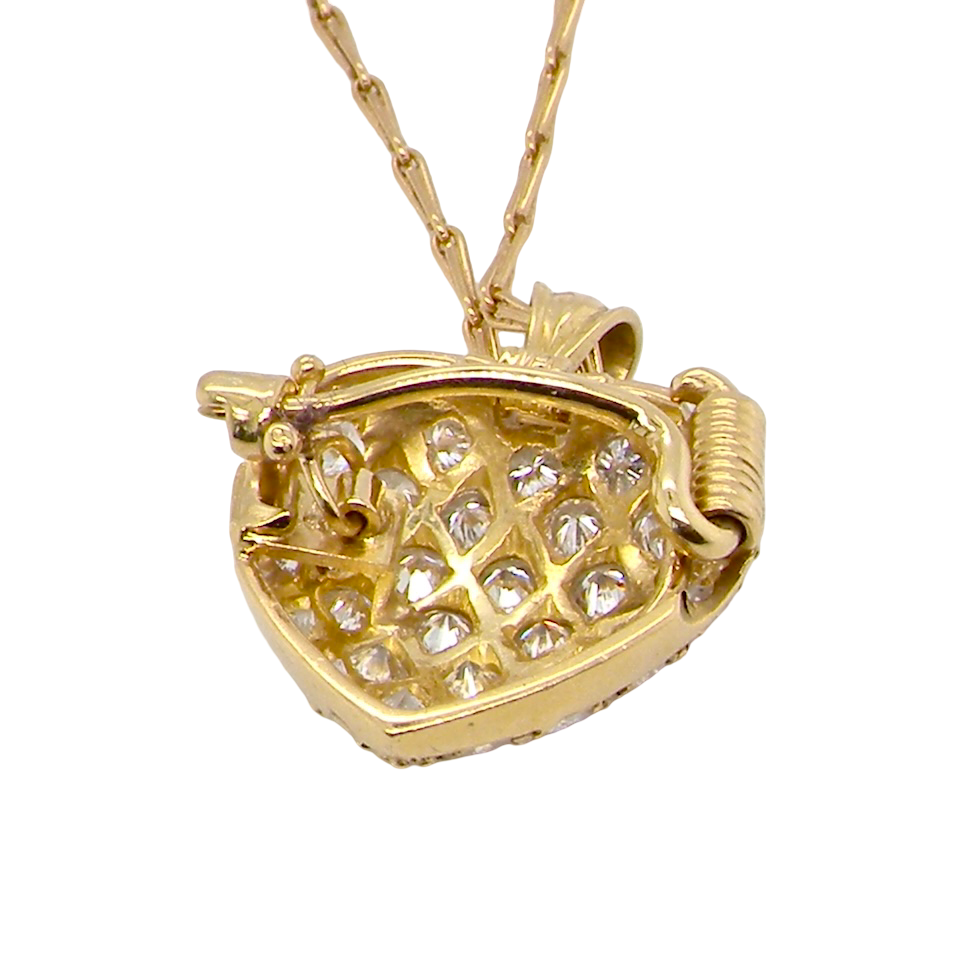 Gold necklace with a heart-shaped pendant on a white background
