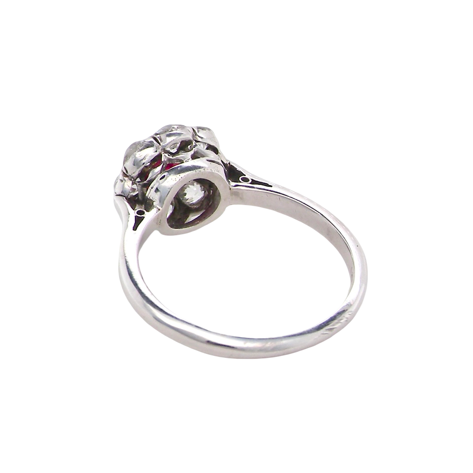 rear A beautiful cluster ring set with a raspberry-red ruby centre stone measuring 5mm in diameter, estimated at approximately 0.50 carats.