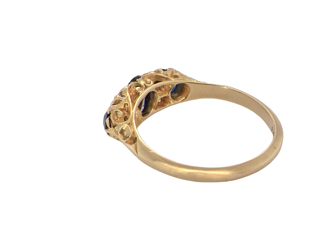 rear A beautiful Edwardian sapphire and diamond ring, dating to 1907, crafted in 18 carat gold with a traditional hand-carved boat-shaped setting.