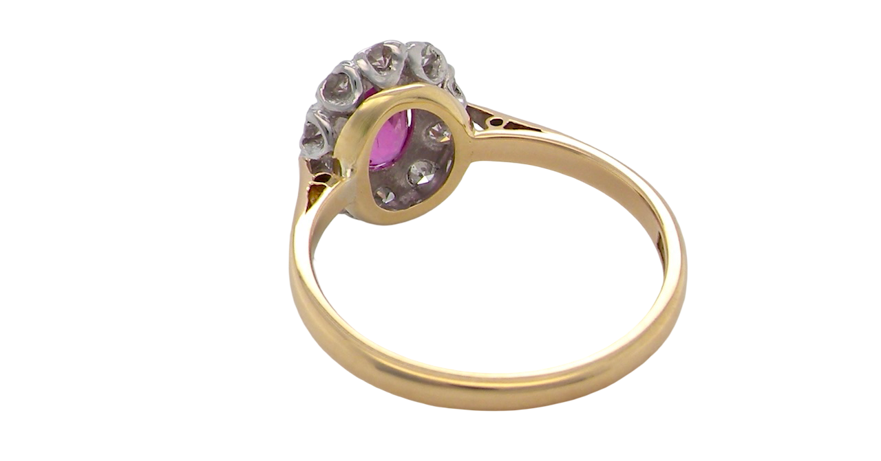 rear A beautiful vintage cluster ring showcasing a vivid pink sapphire centre stone, measuring approximately 6.6 × 4.3 mm(estimated 0.65 carats).