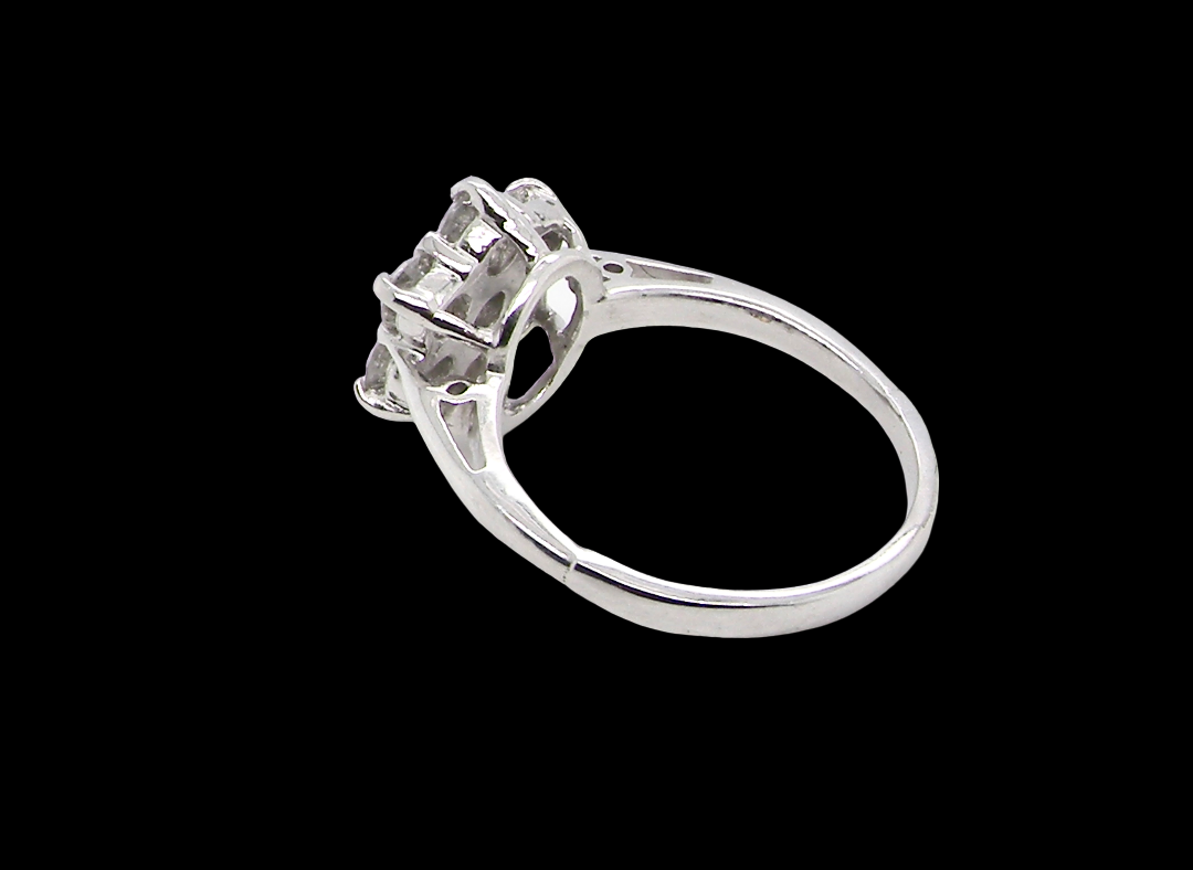 rear A beautiful vintage diamond cluster ring, elegantly set with seven brilliant-cut white diamonds in a timeless floral cluster design.