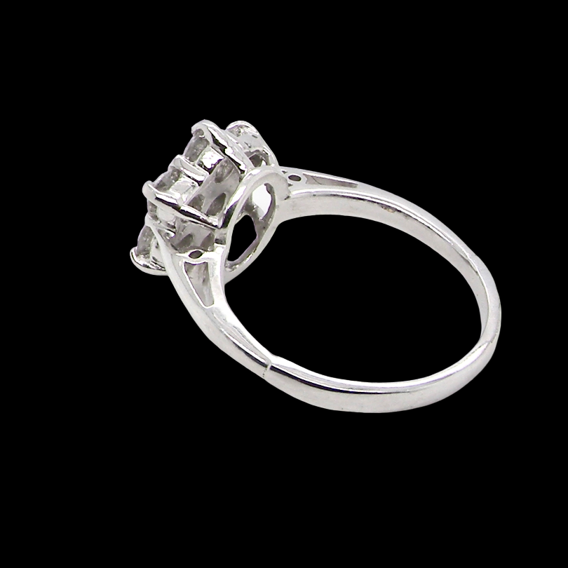 rear A beautiful vintage diamond cluster ring, elegantly set with seven brilliant-cut white diamonds in a timeless floral cluster design.