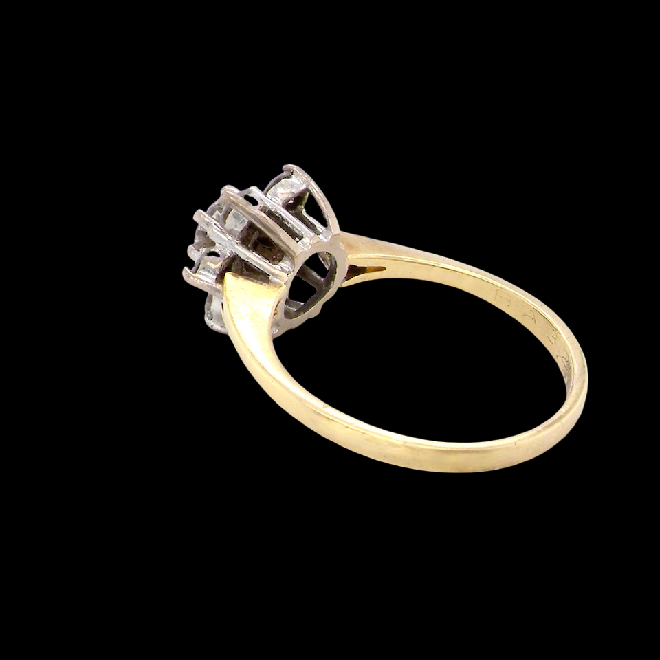 rear A beautifully crafted vintage diamond cluster ring, dating to the 1960s, featuring a classic floral-inspired design that remains timeless and elegant.