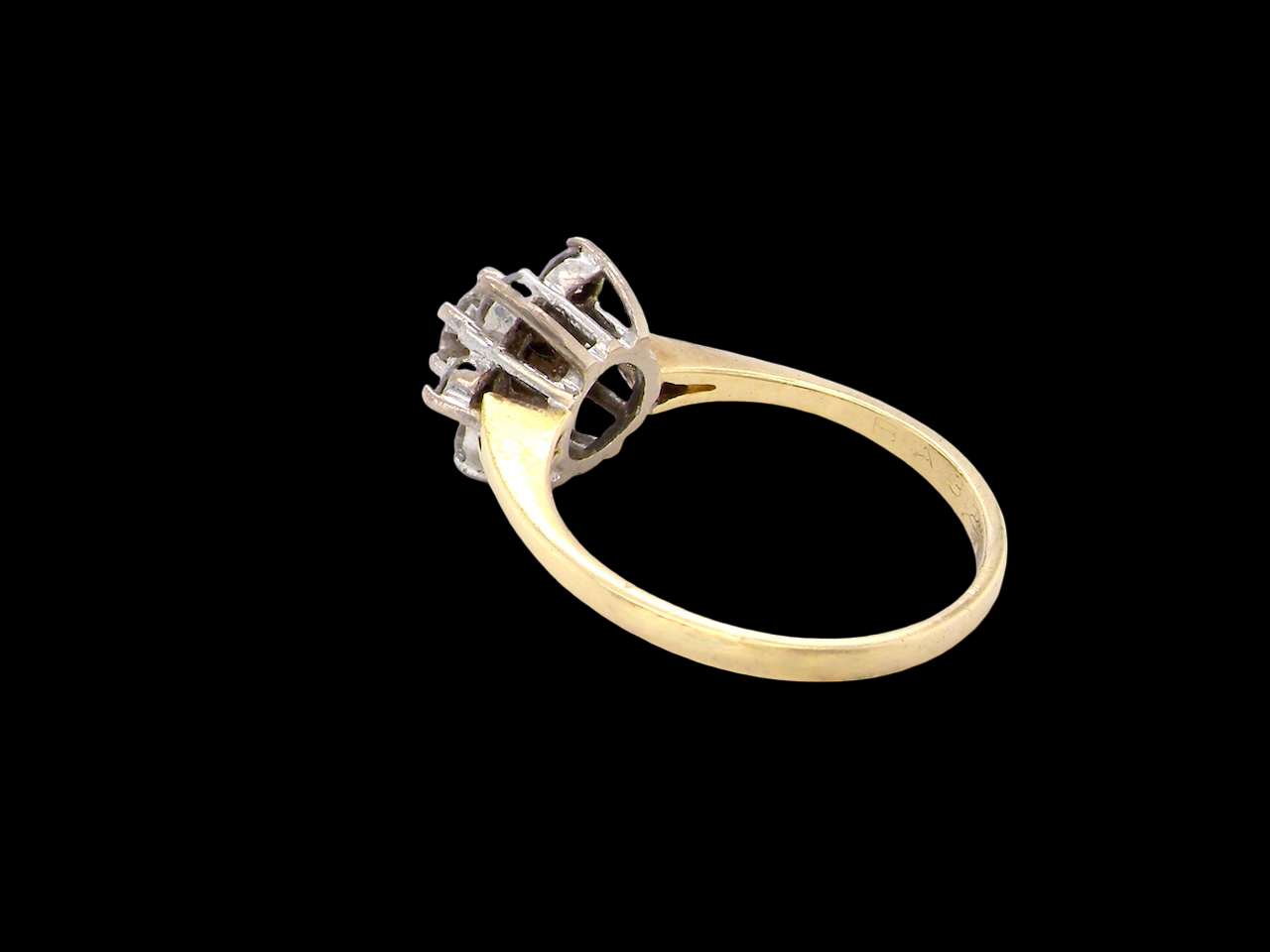 rear A beautifully crafted vintage diamond cluster ring, dating to the 1960s, featuring a classic floral-inspired design that remains timeless and elegant.