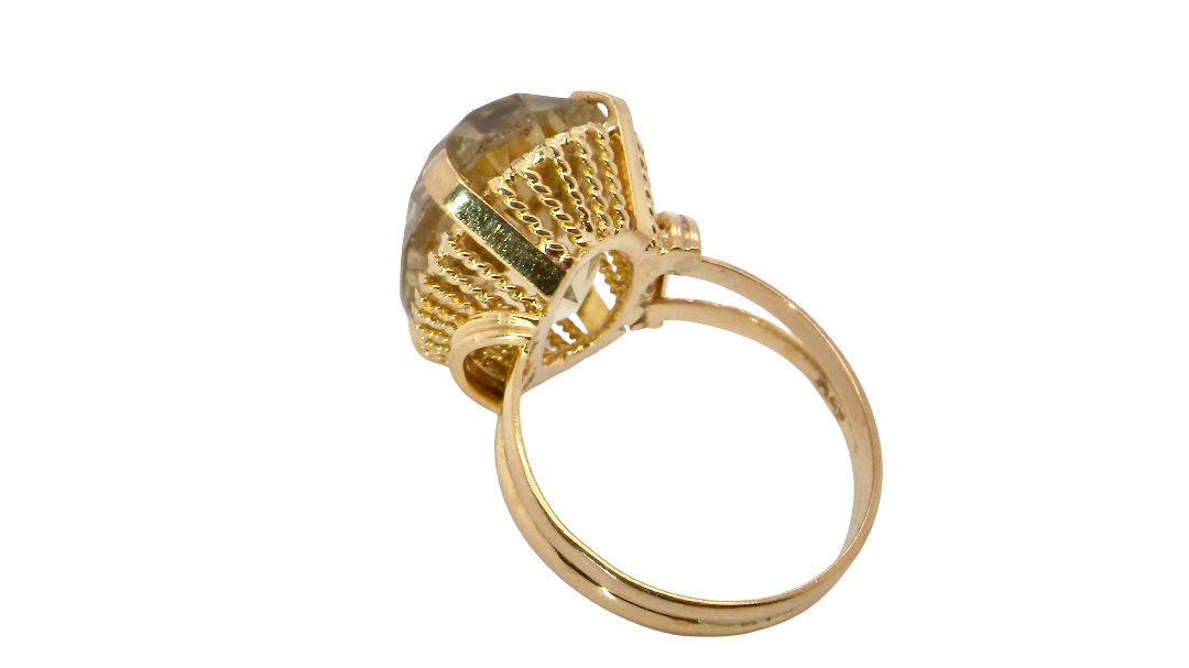 rear A continental dress ring that tests as 18 carat gold. Features a large citrine gemstone, that measures 18x13mm, depth 9mm. Golden yellow with a hint of olive green. 