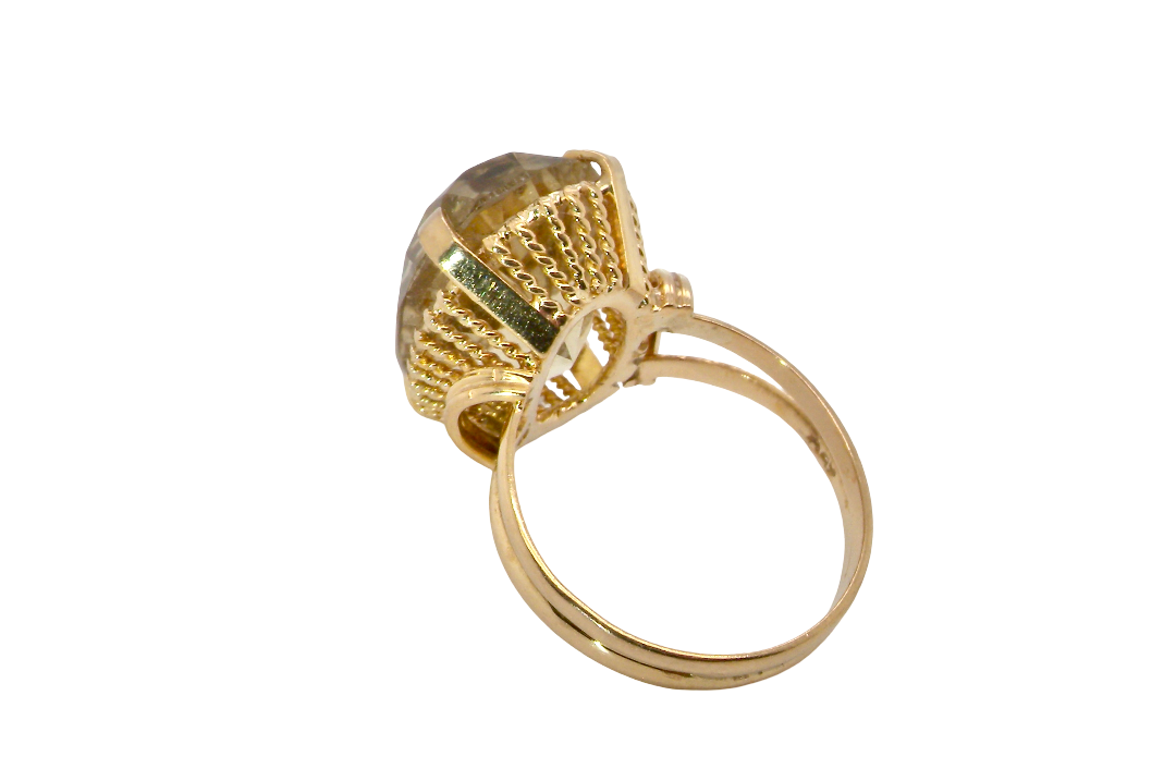 rear A continental dress ring that tests as 18 carat gold. Features a large citrine gemstone, that measures 18x13mm, depth 9mm. Golden yellow with a hint of olive green. 