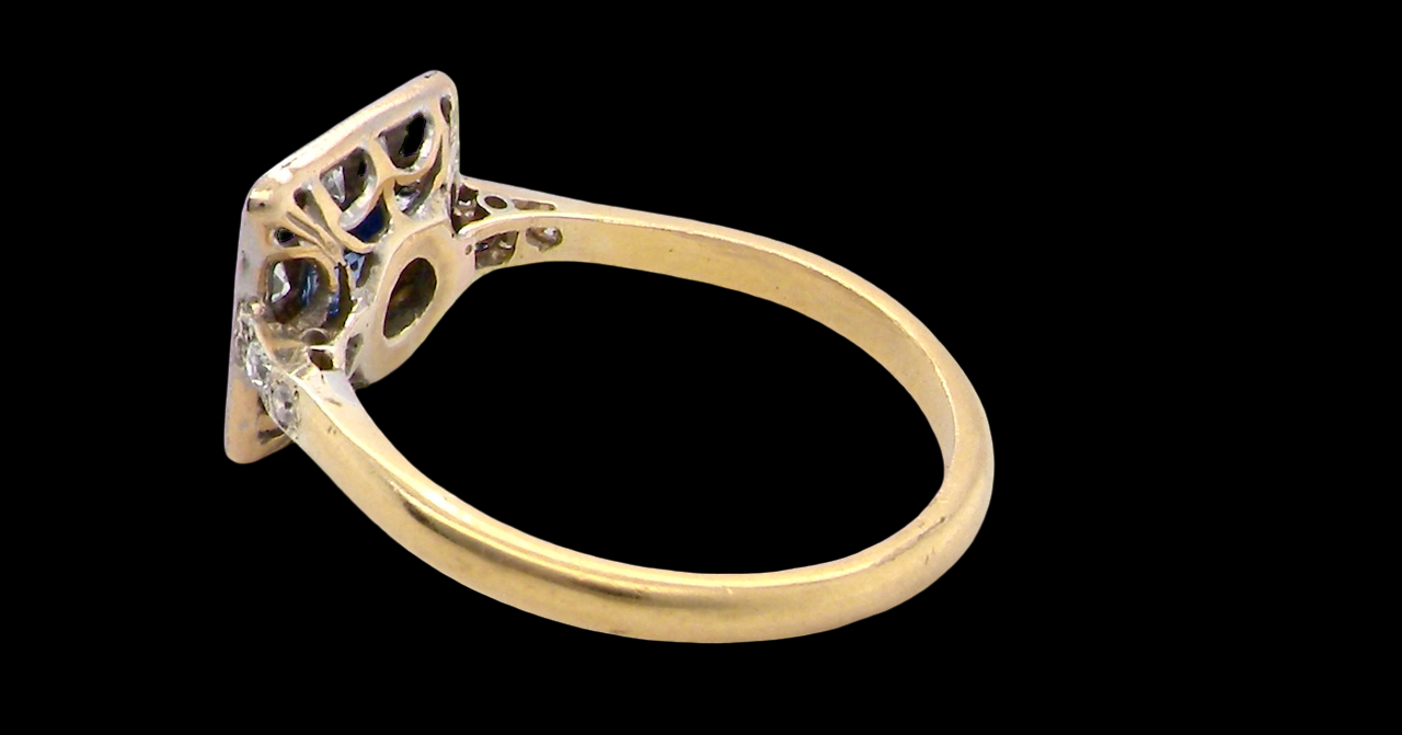 rear A fine Art Deco cluster ring. The centre stone a square sapphire 5x5mm (est 0.50 carats) in a mille grain setting.
