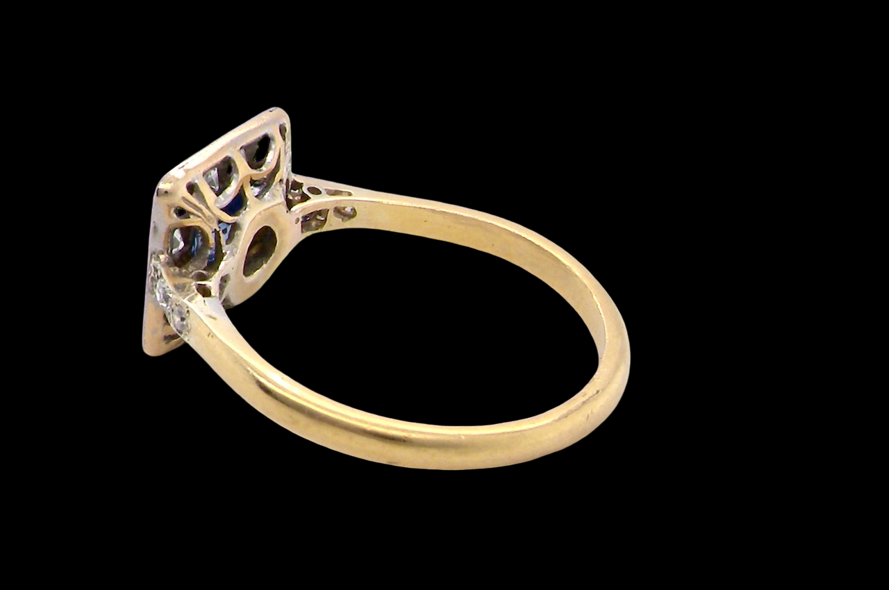 rear A fine Art Deco cluster ring. The centre stone a square sapphire 5x5mm (est 0.50 carats) in a mille grain setting.