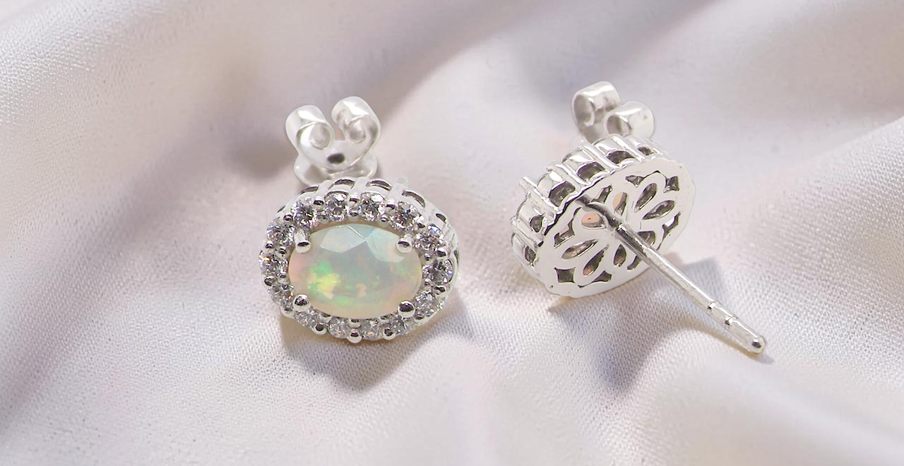rear A fine and elegant pair of platinum* stud earrings, each beautifully set with an exceptional white opal measuring 7 x 5mm. T