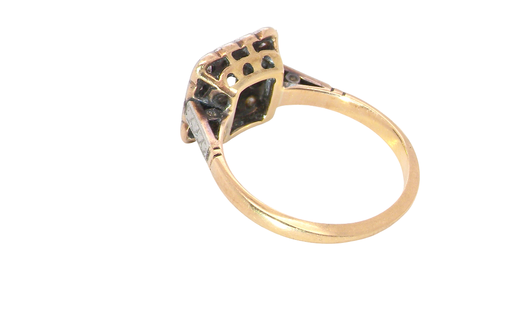 rear A fine antique ring from the early part of the 20th century (probably 1915-1925)
A square head that measures 11x11mm is set with old brilliant cut white diamonds. The principal stone measures just over half a carat (5.2mm) colour i-l, clarity Si, rim setting, platinum.