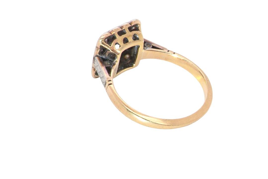 rear A fine antique ring from the early part of the 20th century (probably 1915-1925)
A square head that measures 11x11mm is set with old brilliant cut white diamonds. The principal stone measures just over half a carat (5.2mm) colour i-l, clarity Si, rim setting, platinum.