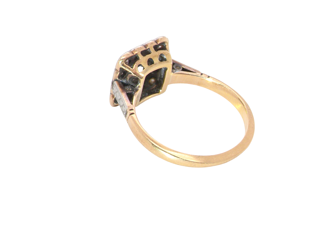 rear A fine antique ring from the early part of the 20th century (probably 1915-1925)
A square head that measures 11x11mm is set with old brilliant cut white diamonds. The principal stone measures just over half a carat (5.2mm) colour i-l, clarity Si, rim setting, platinum.