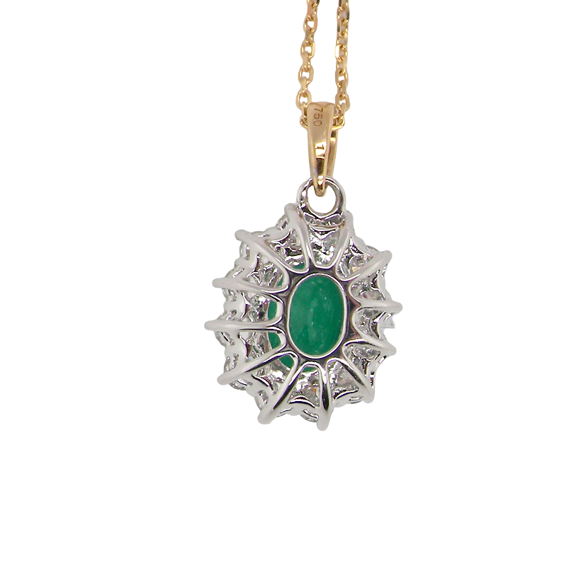 rear A fine cluster pendant. Features at the centre an oval cut emerald, measures 7.5x5mm (est one carat). Dark green hue, natural inclusions.
