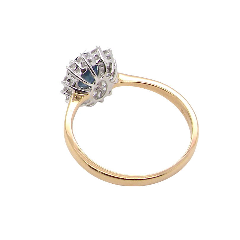rear A fine cluster ring that features a black blue oval cut sapphire that measures 7x5mm (est 0.75 carats)