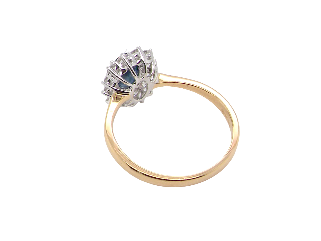 rear A fine cluster ring that features a black blue oval cut sapphire that measures 7x5mm (est 0.75 carats)
