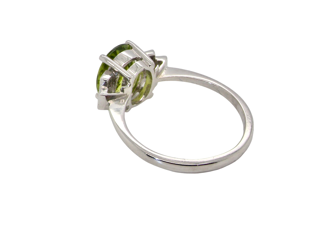 rear A fine gem set ring featuring a vibrant lime-green oval faceted peridot,