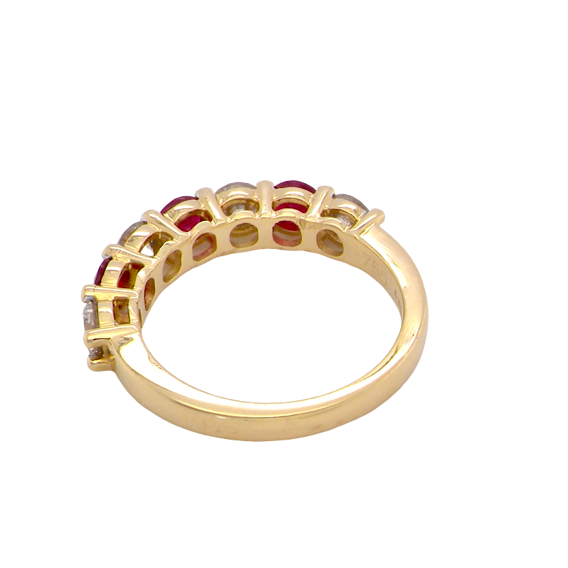 rear A fine half hoop ring. 18 carat gold set with three rubies, each 3.8mm (est 0.20 carats, total 0.67 carats) and four brilliant cut white diamonds, each 3.8mm (total 0.85 carats) 