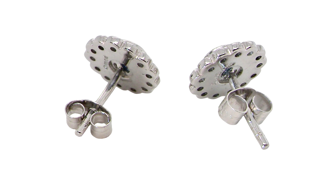 rear A fine pair of 18 carat white gold sapphire and diamond cluster earrings.
Each earring is set with a central round sapphire measuring approximately 3.4mm in diameter, estimated at 0.15ct,