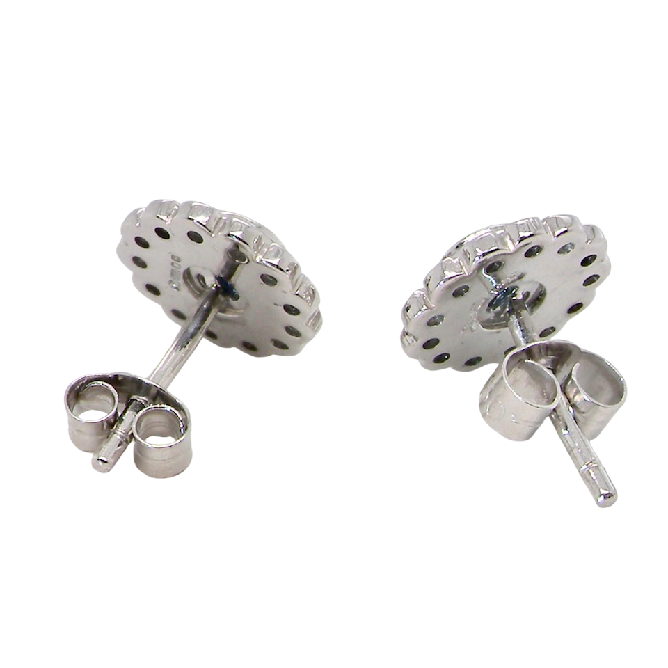 rear A fine pair of 18 carat white gold sapphire and diamond cluster earrings.
Each earring is set with a central round sapphire measuring approximately 3.4mm in diameter, estimated at 0.15ct,