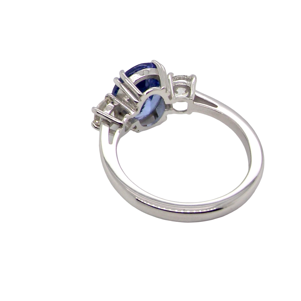rear A fine three stone trilogy ring. The centre stone a 4A tanzanite gem stone, measures 10x8mm (est 3 carats) 