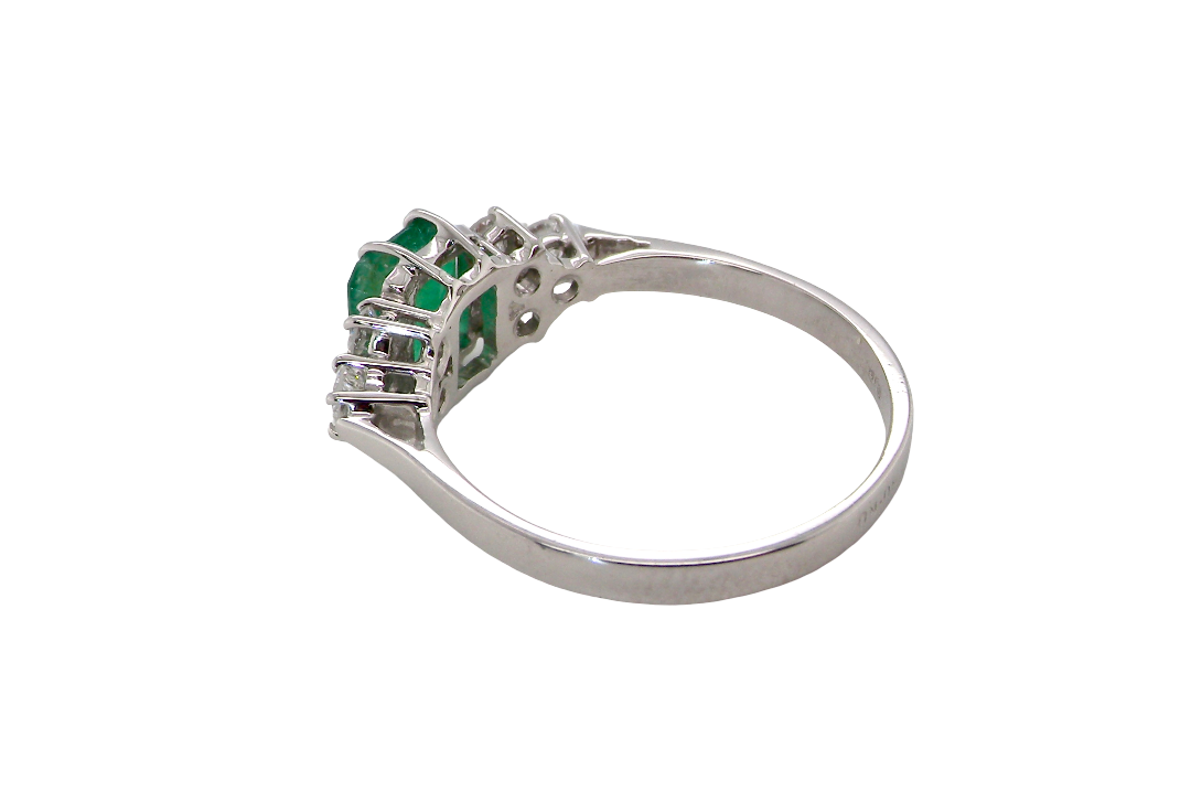 rear A fine white gold* ring that features a rectangular emerald centre stone, measures 6x6.5mm (est one carat), mid to dark green hue, natural inclusions as with most emeralds.