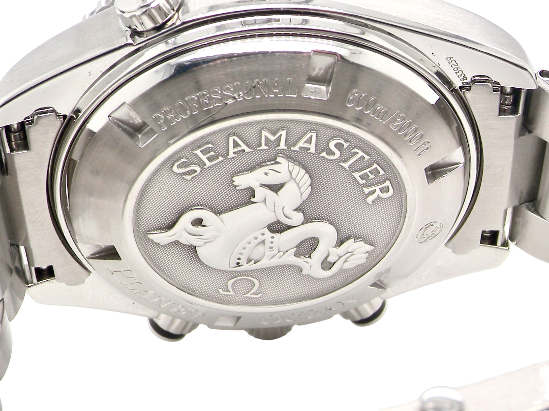 Close-up of the back case of a stainless steel Seamaster watch, showing the engraved Seamaster logo and text on a white background.