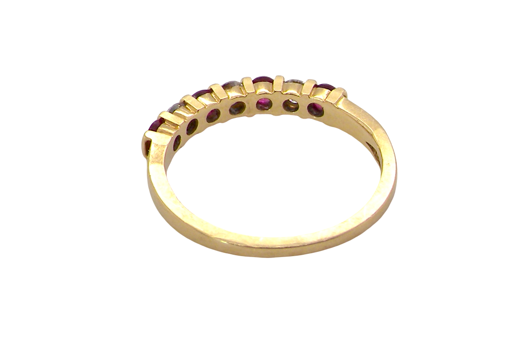 rear A half hoop 18 carat yellow gold eternity ring. Set with four bright red rubies, each 2.6mm (total carat weight 0.28 est)