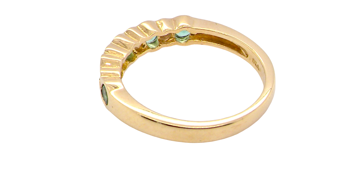 rear A half hoop eternity ring. Set with five round emeralds, each 3mm (0.10 carats) and set with an alternate brilliant cut white diamond, 2.4mm each (total 0.20 carats)