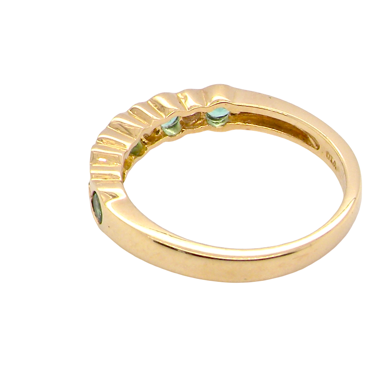 rear A half hoop eternity ring. Set with five round emeralds, each 3mm (0.10 carats) and set with an alternate brilliant cut white diamond, 2.4mm each (total 0.20 carats)