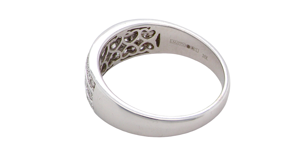rear A lovely 18 carat white gold half hoop ring. Set with a middle row of nine bright white brilliant cut diamonds, graduate from 2.2mm to 2.6mm. The top and bottom rows are also set with small diamonds.