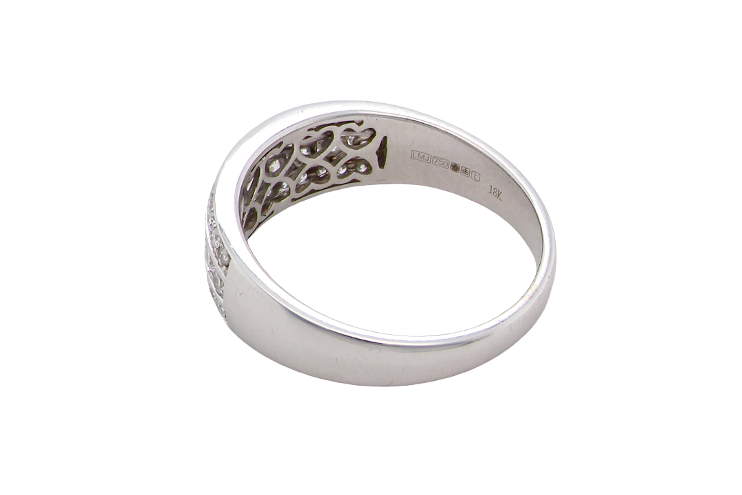 rear A lovely 18 carat white gold half hoop ring. Set with a middle row of nine bright white brilliant cut diamonds, graduate from 2.2mm to 2.6mm. The top and bottom rows are also set with small diamonds.