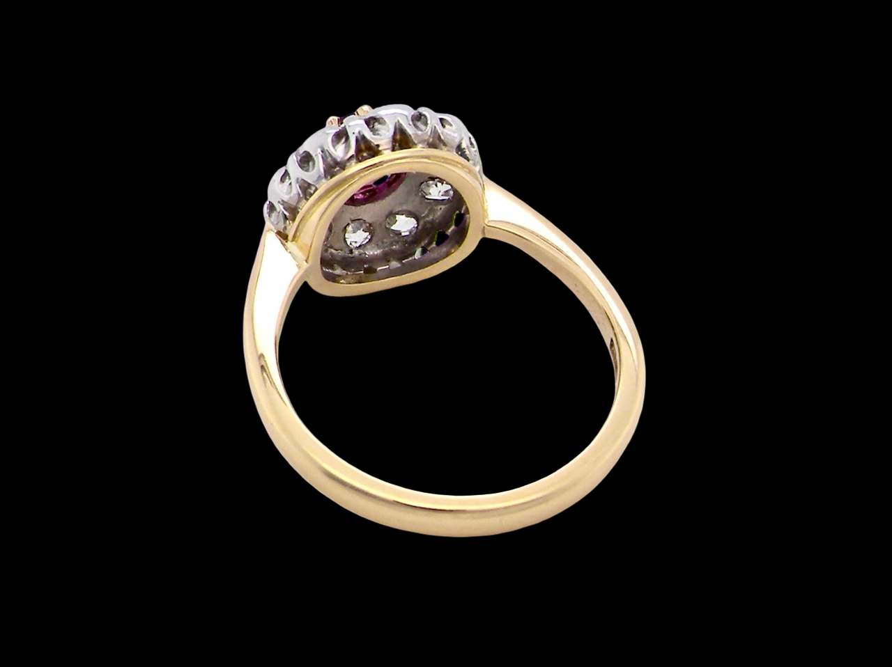 rear A lovely daisy cluster ring that profiles to the centre a deep red ruby, 5mm (0.50 carats) yellow claw set.