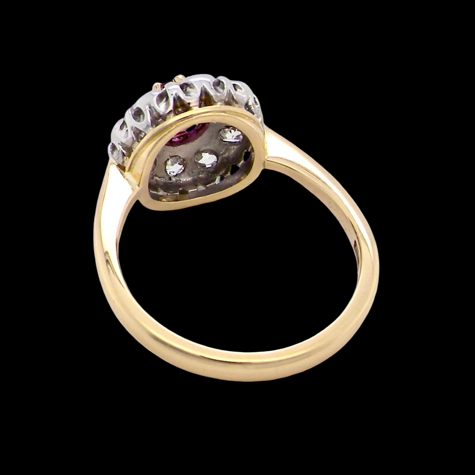 rear A lovely daisy cluster ring that profiles to the centre a deep red ruby, 5mm (0.50 carats) yellow claw set.