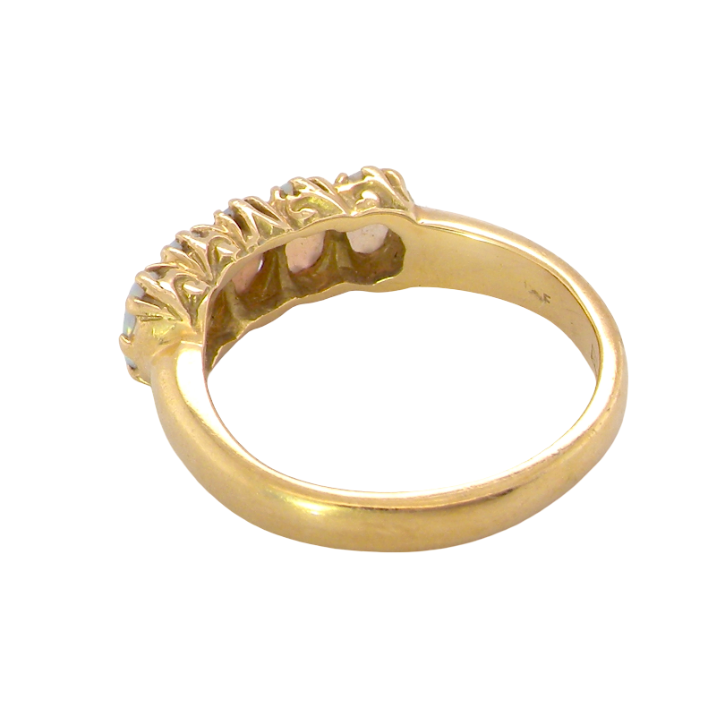 rear A lovely five stone ring. Set with five oval white opals, each 5x3.5mm, good play of colour on all.
Carved head