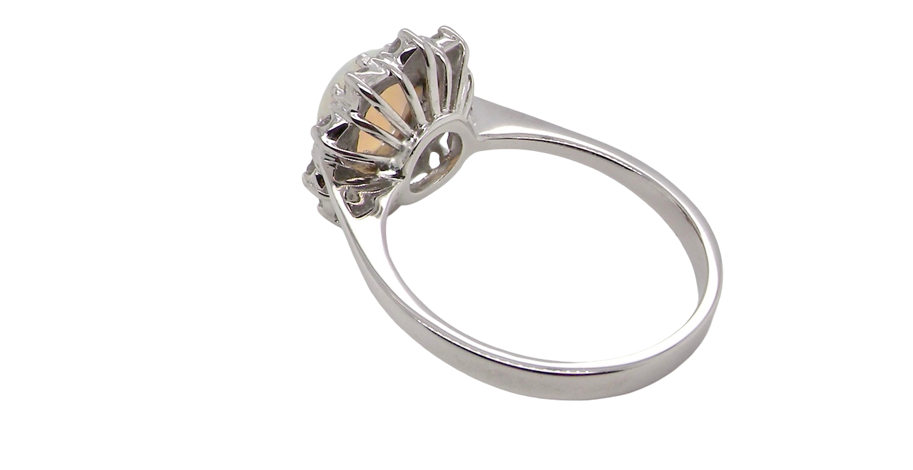 rear A lovely white gold cluster ring. Features to the centre an oval white opal, 9x7mm, with an excellent play of colour.