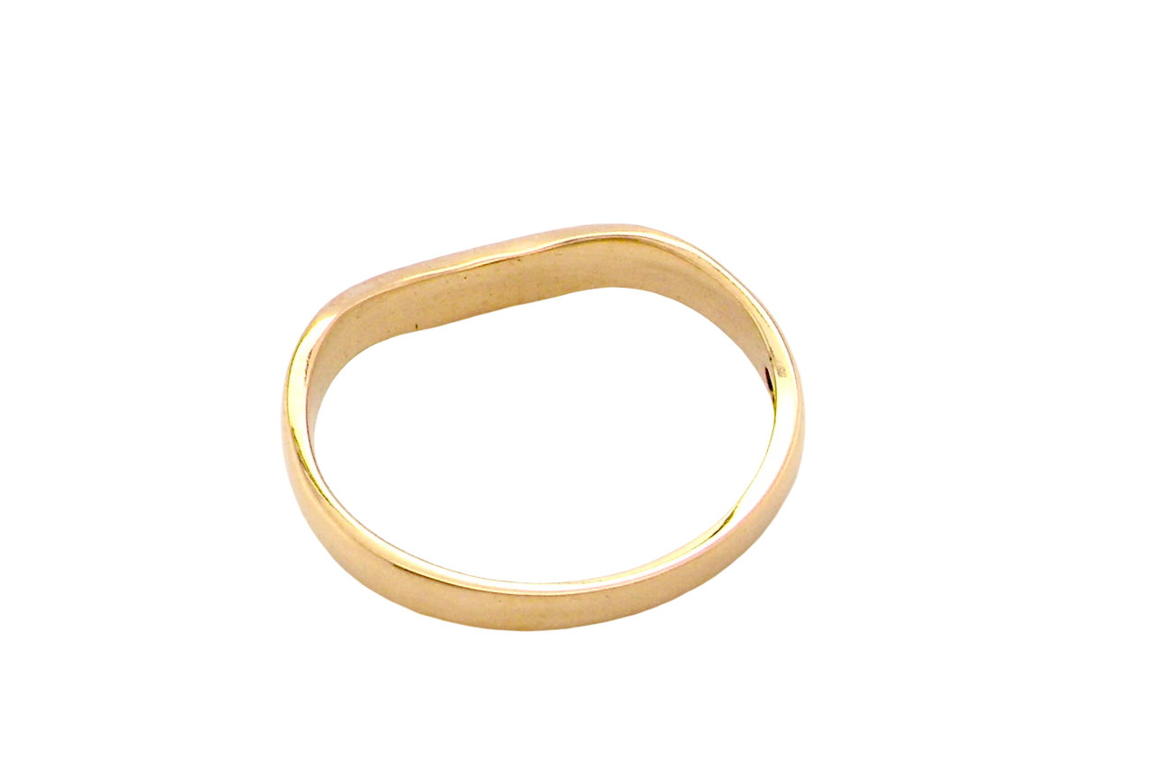 rear A narrow 18 carat yellow gold wedding ring. This has a U shape which makes the placing of a cluster or even a solitaire engagement ring that much easier to place against as it will sit with the 'U'