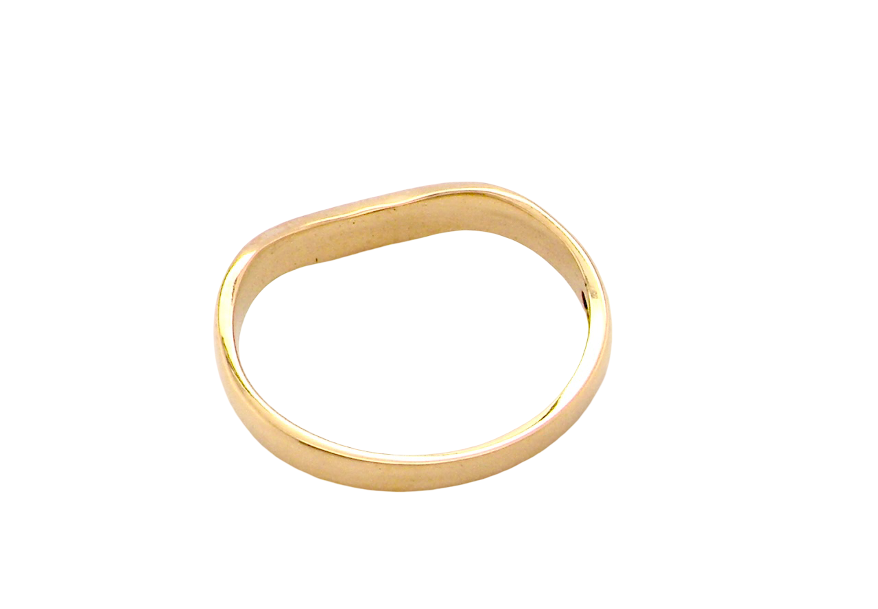 rear A narrow 18 carat yellow gold wedding ring. This has a U shape which makes the placing of a cluster or even a solitaire engagement ring that much easier to place against as it will sit with the 'U'