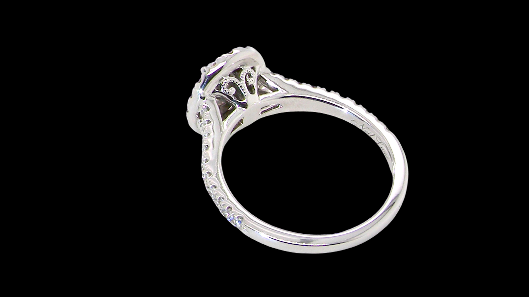 rear A new diamond cluster ring* An oval diamond halo cluster ring. Set with brilliant cut white diamonds, colour H-k, clarity Si.