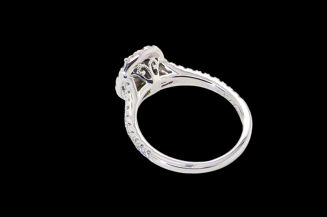 rear A new diamond cluster ring* An oval diamond halo cluster ring. Set with brilliant cut white diamonds, colour H-k, clarity Si.