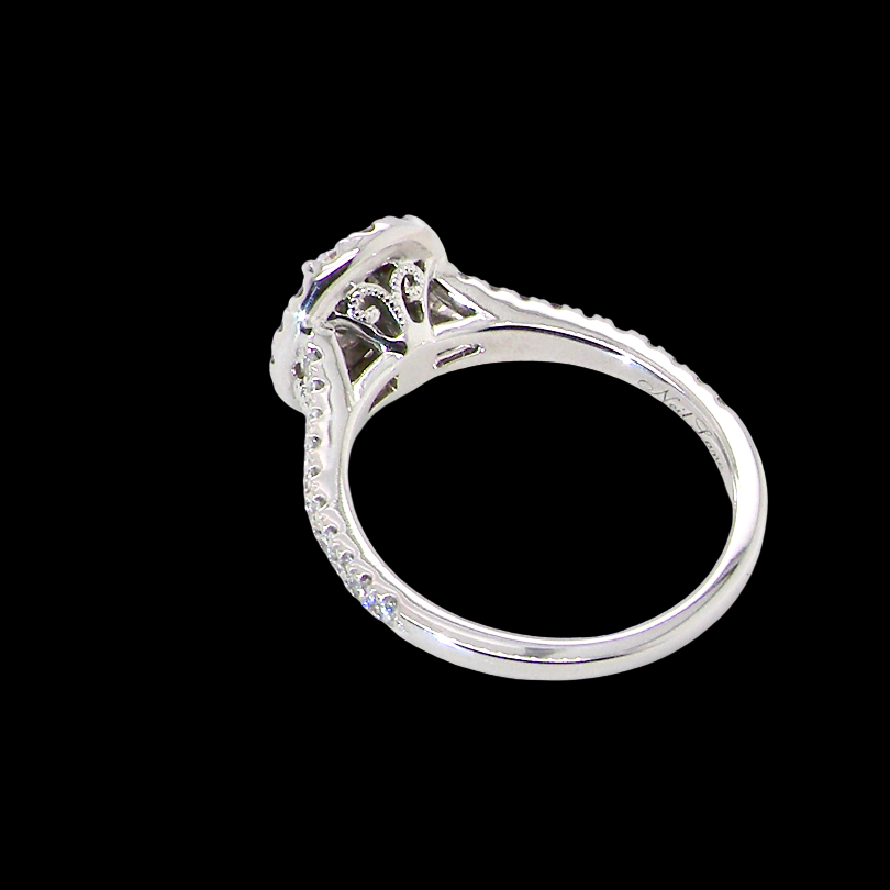 rear A new diamond cluster ring* An oval diamond halo cluster ring. Set with brilliant cut white diamonds, colour H-k, clarity Si.