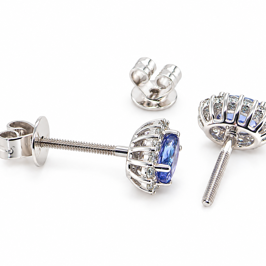 rear A pair of 18 carat white gold cluster earrings.
Features an oval tanzanite gemstone,