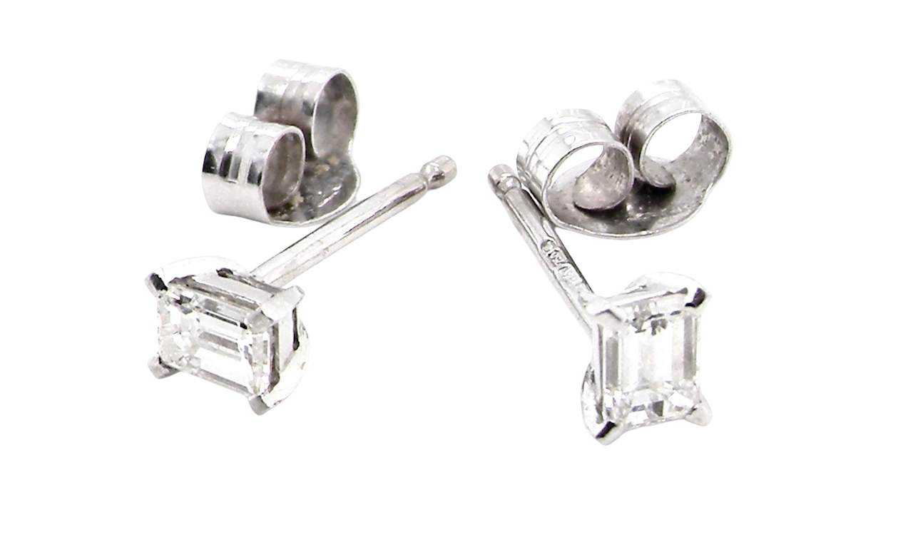 A pair of emerald cut diamond earrings