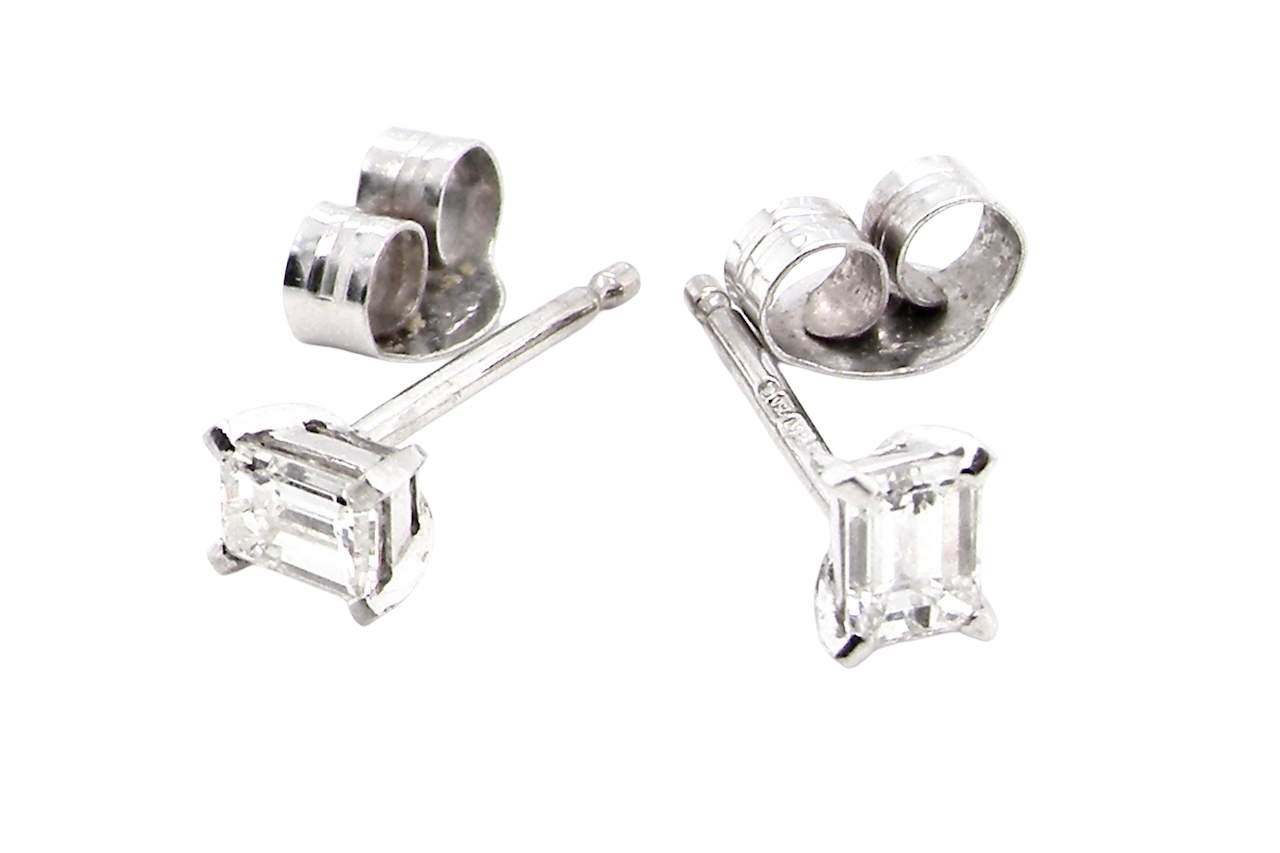 A pair of emerald cut diamond earrings