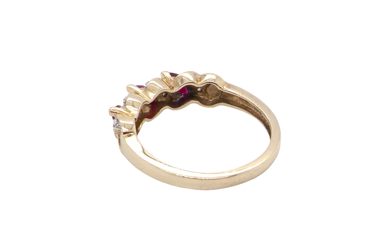 rear A pretty 9 carat gold dress ring. The three rubies are marquise cut, 5x3mm each, and set at an angle .