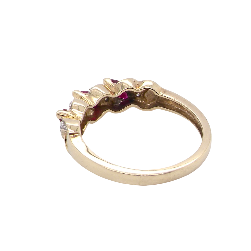 rear A pretty 9 carat gold dress ring. The three rubies are marquise cut, 5x3mm each, and set at an angle .